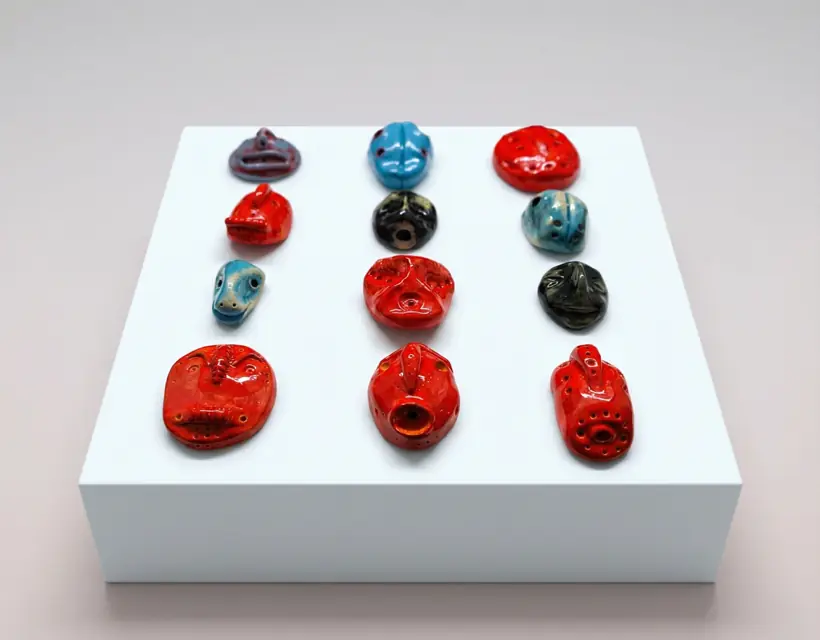 Faces by Elena Danescu, glazed ceramic pendants